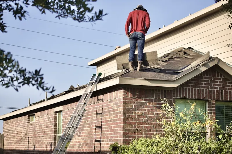 Professional roofer working on a residential roof in Leektown
